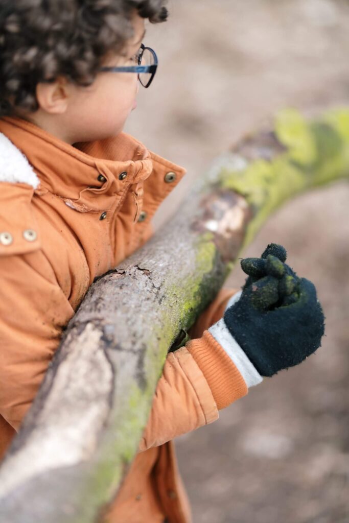 Zo Kinderopvang Outdoor BSO jongen staat bij boomstam